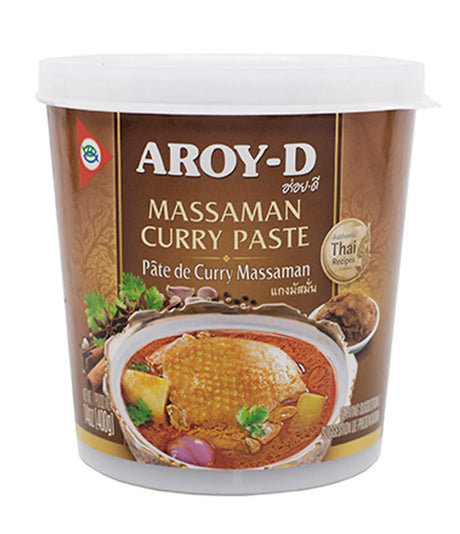 A container of Aroy-D Massaman Curry Paste with an image of the curry on the label, indicating it is a product of Thailand.