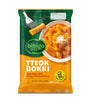 Packaging of bibigo Tteok Bokki with a bowl of rice cake and cheese sauce on a white background