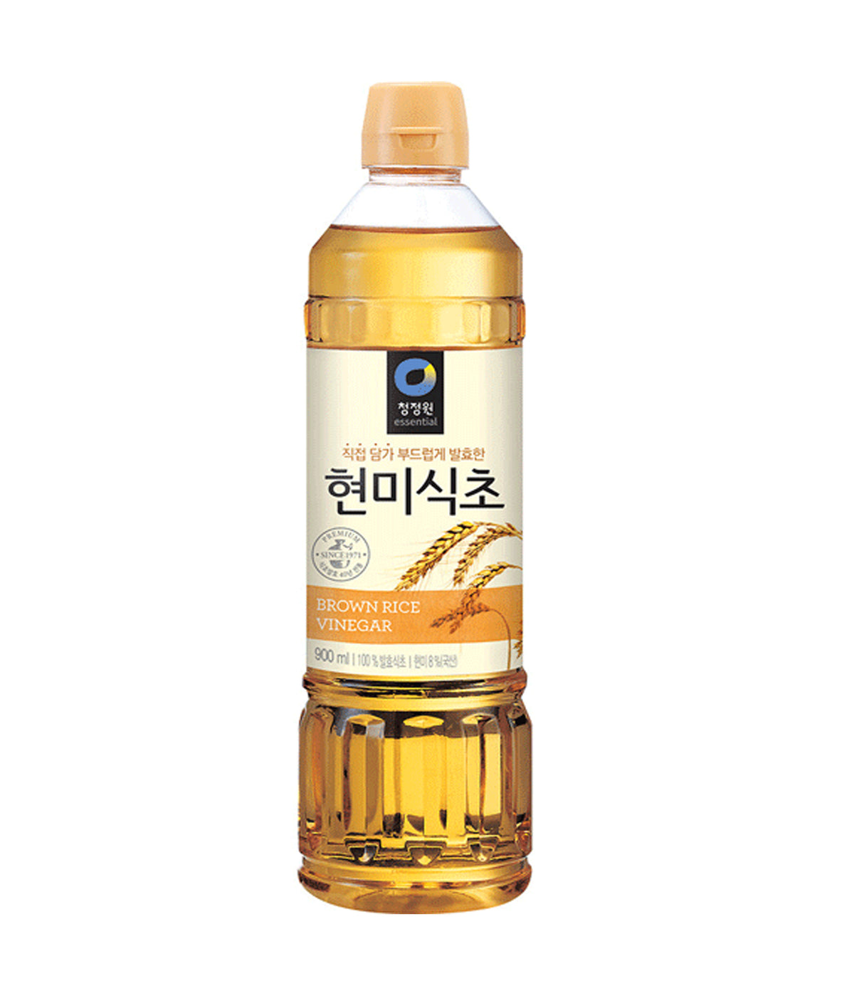 A bottle of Daesang Brown Rice Vinegar with Korean labeling, predominantly clear and yellow in color.
