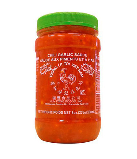 A jar of Huy Fong Foods Chili Garlic Sauce, 226g, with a red label and green lid.