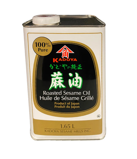 A 1.65L metal can of Kadoya 100% Pure Roasted Sesame Oil with black and white label, predominantly black with red and green accents.