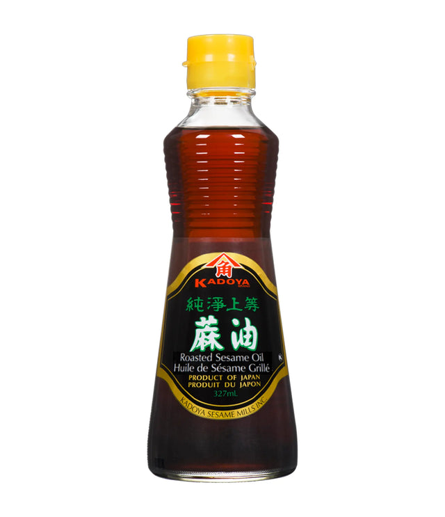 A bottle of Kadoya Roasted Sesame Oil 100% Pure with a yellow cap on a white background.