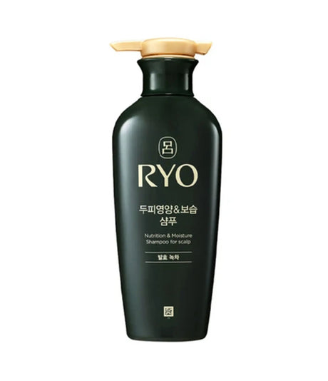 Black shampoo bottle with gold cap on a white background