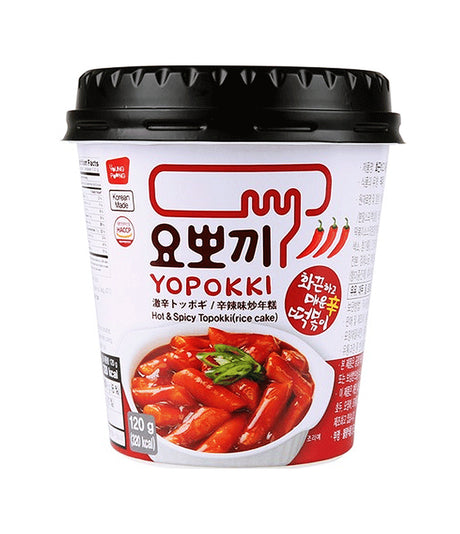 A cup of Young Poong Yopokki Hot & Spicy Topokki, showing the product packaging with Korean text and an image of the spicy noodles on the front.