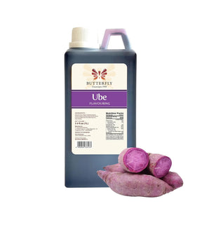 A bottle of Butterfly Ube Flavouring Extract Paste alongside whole purple sweet potatoes.