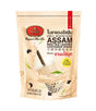 A stand-up pouch of Assam Red Tea Leaves Bubble Milk Tea by Nestlé, featuring a beige background with illustrations of a milk tea splash, black tea leaves, and a glass of bubble tea with tapioca pearls.