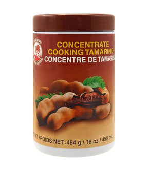 A jar of Cock Brand Concentrate Cooking Tamarind, showing the product name and an image of tamarind fruits on the label.