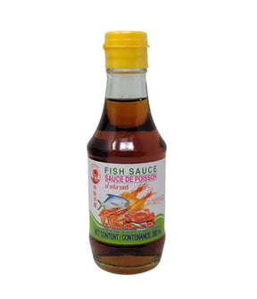 A bottle of Cock Brand Fish Sauce, 200ml, with a label showing the product name and an image of a fish, indicating it is a culinary sauce.