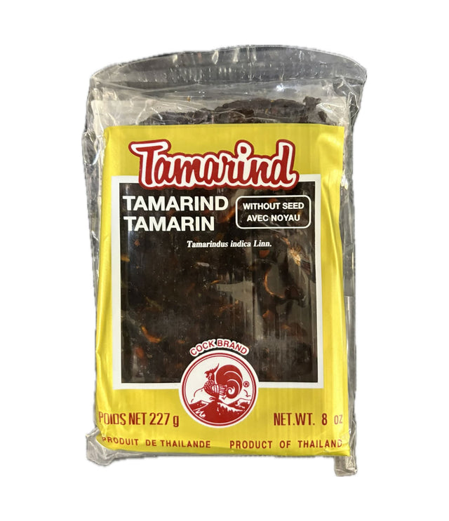 A 8 oz bag of Tamarind without seed, featuring a bright yellow label with red and white text and a photo of dark brown tamarind pieces inside a clear plastic pouch.