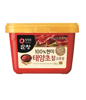 A container of Daesang Hot Pepper Paste (Gochujang) with a red label, predominantly displaying the product name and an image of the paste.