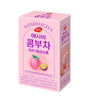 Kombucha box with pink packaging featuring a fruit illustration on a white background