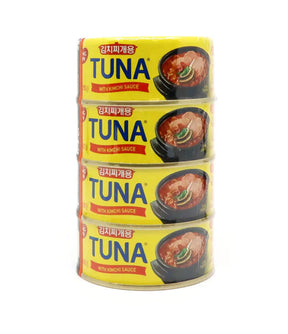 Stack of four canned tuna products with kimchi sauce, each labeled as 'TUNA' with the brand Dongwon visible.