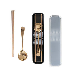 A set of rose gold stainless steel chopsticks and spoon displayed alongside their packaging.