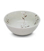 White ceramic bowl with subtle floral patterns on a white background