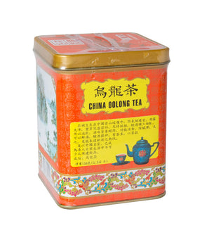 A colorful tin can of Golden Dragon China Oolong Tea with label and decorative patterns.