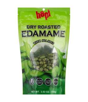 Green package of dry roasted edamame with sea salt on a white background