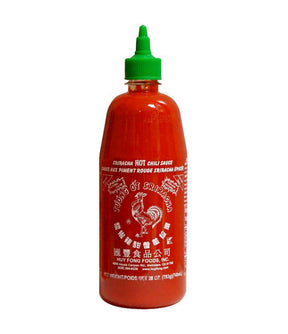 A bottle of Huy Fong Foods Sriracha Hot Chili Sauce with a green cap and a label featuring the brand name and a rooster illustration.
