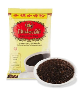 A package of KafeTraMue Brand coffee mixed powder next to a small white bowl filled with dark brown coffee granules, on a plain white background.