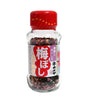 A clear glass bottle of Japanese plum powder seasoning with a red cap and a white and red label featuring Japanese text.