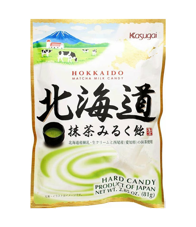 A package of Kasugai Hokkaido Matcha Milk Candy featuring an image of green tea and milk, with Japanese text and a dairy farm illustration.