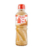 Bottle of Kenko Creamy Golden Sesame Dressing with Japanese labelling, predominantly red and white in color.