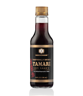 A bottle of Kikkoman Tamari Soy Sauce, 296ml, with a white and orange label, on a white background.