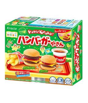 Packaging for Kracie Popin' Cookin' Candy Kit featuring an illustration of a hamburger and a hotdog, along with the text 'HAMBURGER' and 'CANDY'.