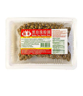 Packaged bubble tea tapioca pearls in a clear plastic container with a label showing product information.