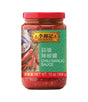 A jar of Lee Kum Kee Chili Garlic Sauce with a label showing the product name and a picture of a spoon with sauce on it.