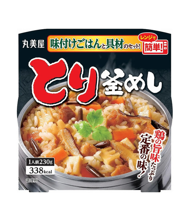 Front-facing package of Japanese instant rice with vegetables and meat, showing a bowl of prepared rice on the front with large red and white Japanese text and a dark background.