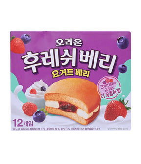A package of Korean yogurt cake, featuring a purple box with illustrations of a strawberry and cream sandwich cake, fresh strawberries, blueberries, and whipped cream. The box has Korean text and is photographed on a clean white background.