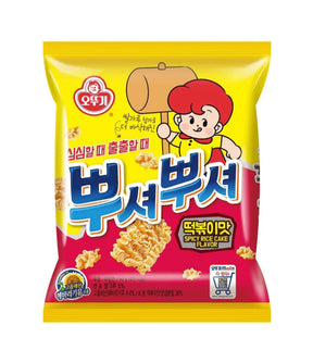 A package of Ottogi Ppushu Ppushu Noodle Snack with Tteokbokki Flavor. The packaging is predominantly yellow with an illustration of a character eating the snack and text in Korean.