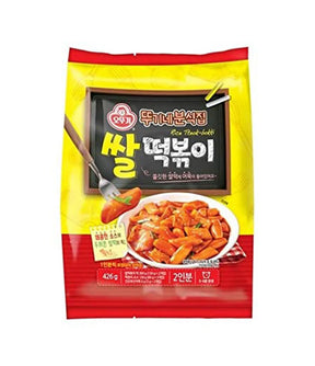 Packaging for Ottogi Spicy Rice Cake (Tteok-bokki) showing the product name, image of the rice cake, and Korean text on a yellow and red background.