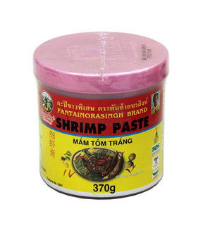 A container of Pantai brand shrimp paste, labeled in Thai and English, with a pink lid and a yellow label featuring an image of the shrimp and text indicating the product is 370g.
