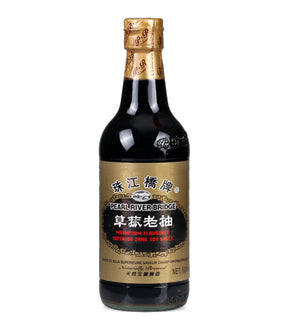 A bottle of Pearl River Bridge mushroom flavor dark soy sauce with a label in Chinese characters and English text.