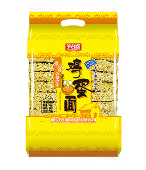 Packaged egg noodles in a yellow bag with Chinese characters and an image of the noodles.