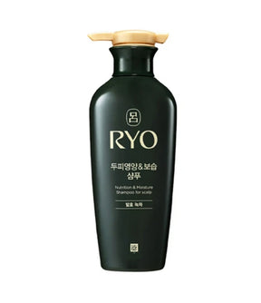 Black shampoo bottle with gold cap on a white background