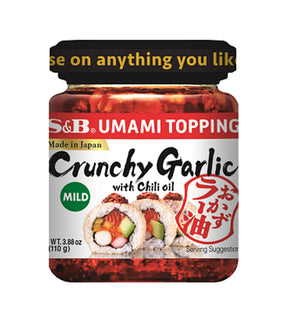 A jar of S&B Umami Topping Crunchy Garlic with Chili Oil 110g, with labels indicating it is made in Japan and mild in heat.
