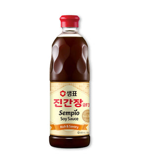 A bottle of Sempio Soy Sauce Jin Gold F3 with a red cap, predominantly dark liquid, with Korean text on the label.