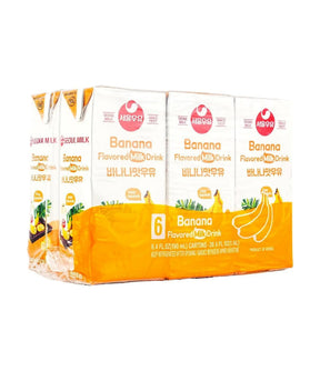 Packaging of Nestle banana-flavored milk drink cartons on a white background
