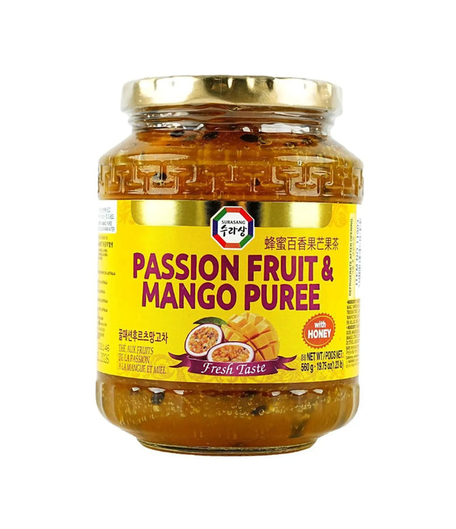Jar of passion fruit and mango puree with a gold lid on a white background
