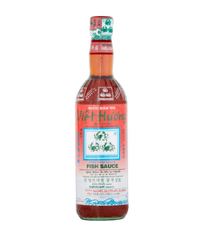Bottle of Three Crabs Brand Fish Sauce with label, predominantly red and white colors.