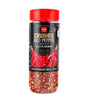 Bottle of crushed red pepper with a red lid on a white background